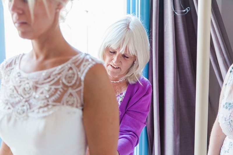 Mother of the Bride Helping the Bride With Her Beaded Maggie Sottero Gown
