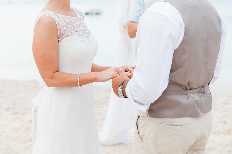 Close Up of Couple Holding Hands During Their Pastel Beach Wedding