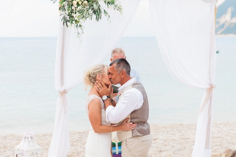 Couples First Kiss During Their Pastel Beach Wedding