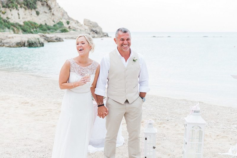 Bride and Groom Laughing During Speeches on Agios Nikitas Beach
