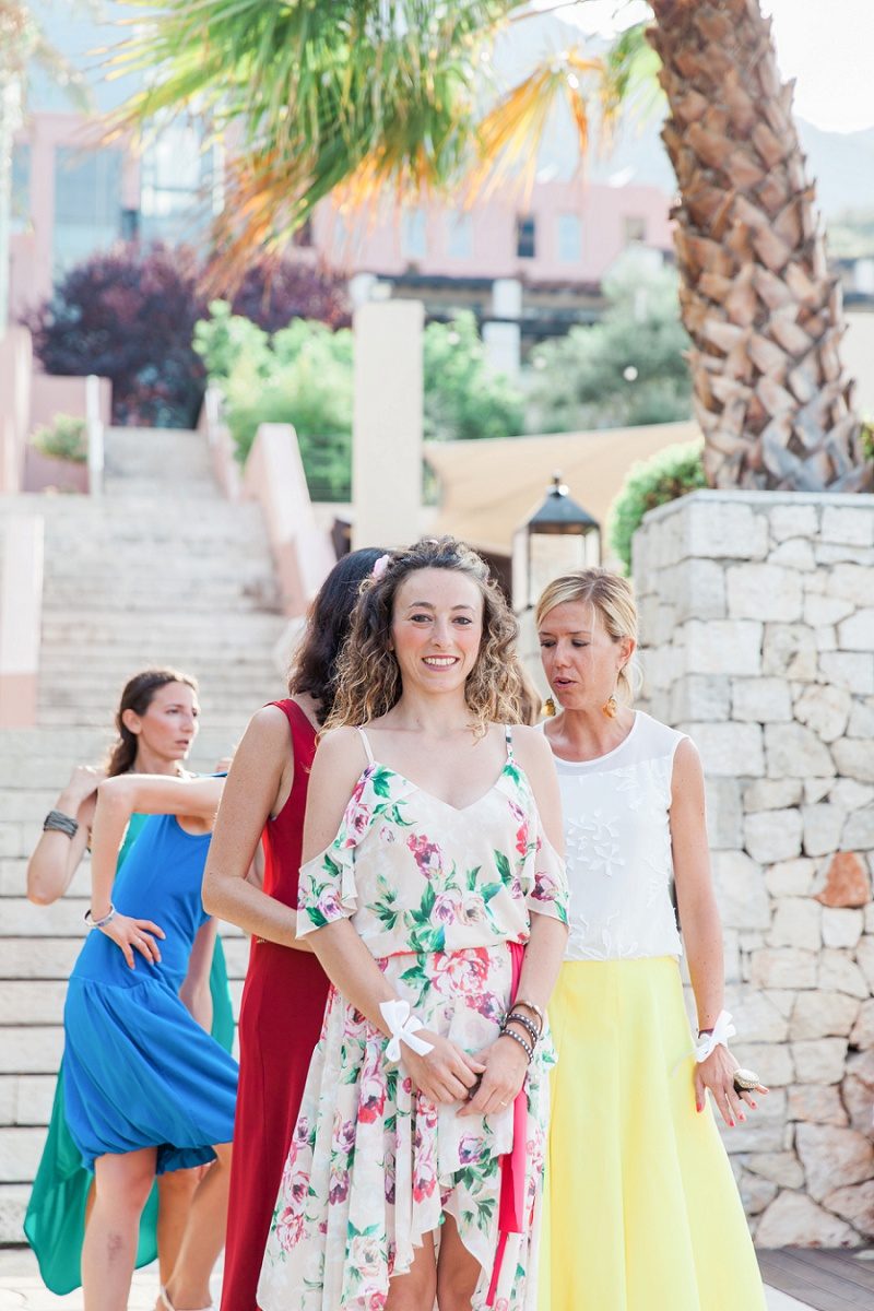 Bridesmaids in Multicoloured Dresses Standing at the Top of the Aisle
