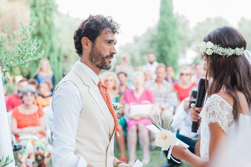 Bride and Groom Exhanging Vows During Their Bohemian Garden Ceremony