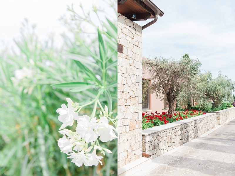 Stone Collumns and White Flowers at the Entrance of Ionian Blue Hotel
