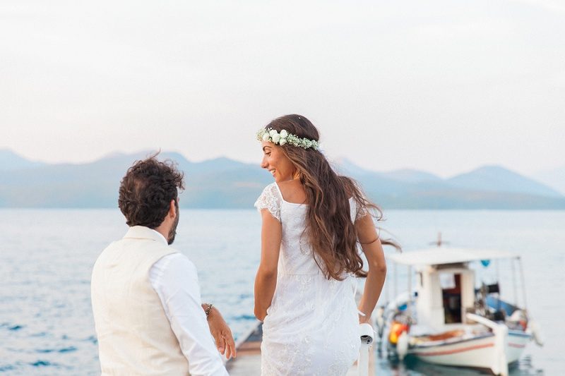 Bride and Groom With A Traditional Greek Boat at Ionian Blue Hotel