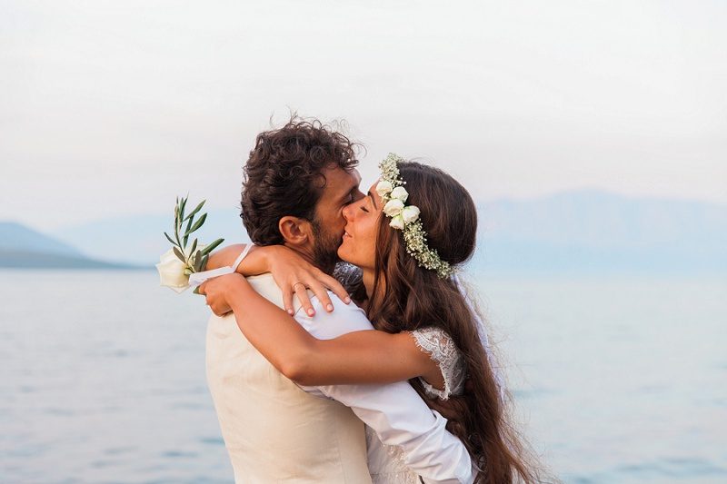 Bride and Groom Hugging Against the Backdrop of the Ionian Sea