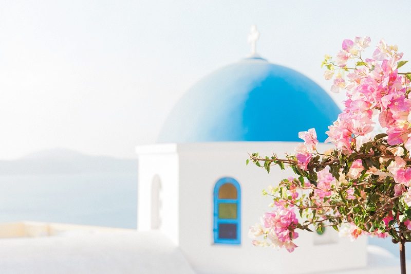Blue and White Church and Pink Bougainvillea in Oia Santorini