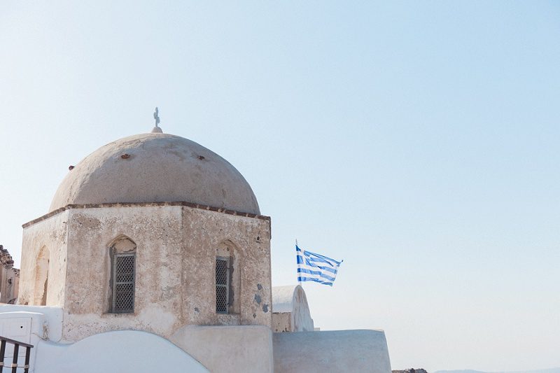 One of the Oldest Churches in Oia Santorini with the Greek Flag Flying