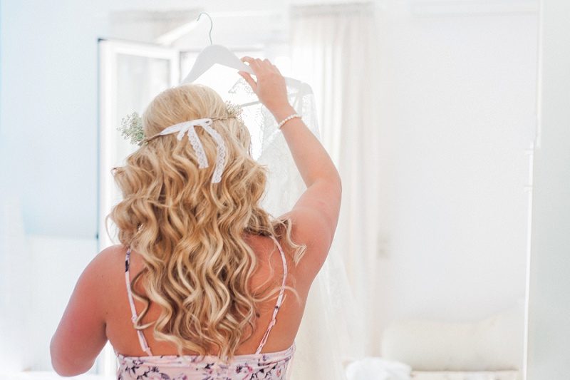 Bride Getting Ready To Put On Her Lace Wedding Dress