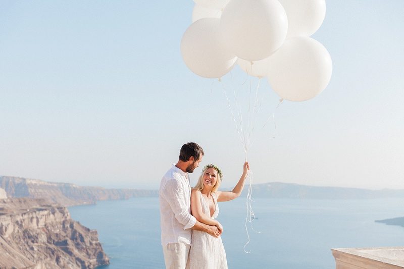Happy Couple with Giant White Balloons In Santorini