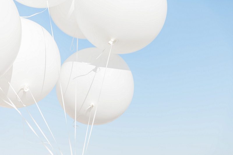 Giant White Balloons Against The Sky In Santorini