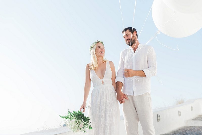 Newlyweds in Fira With Giant White Balloons