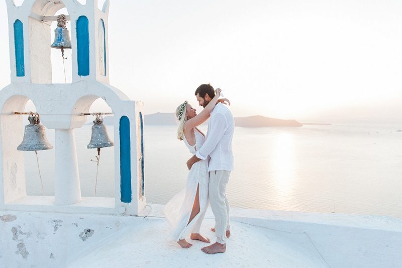 Bride and Groom on a Church Roof After Their Sunset Elopement in Santorini