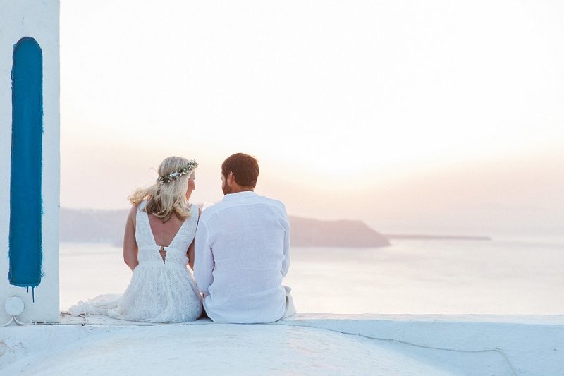 Couple On A Church Rooftop After Their Sunset Elopement in Santorini