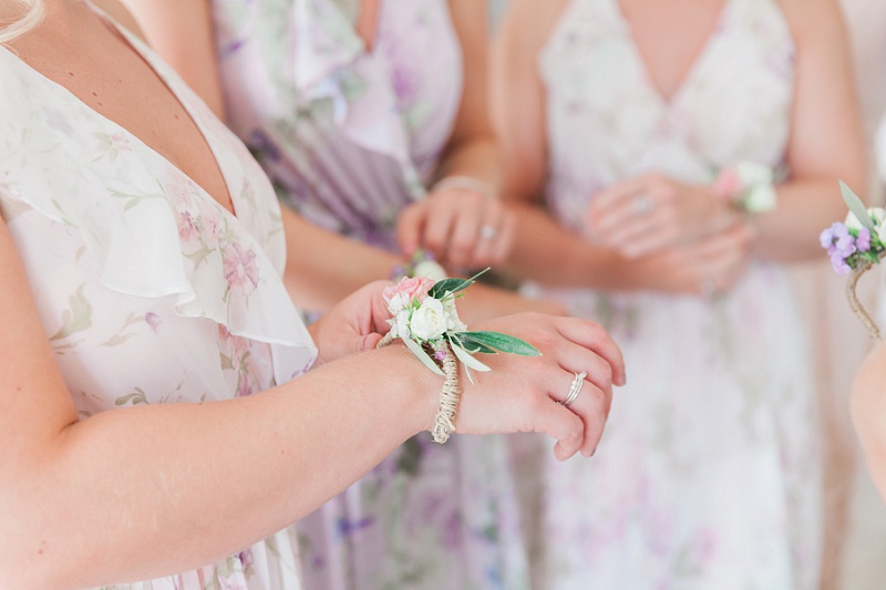 Bridesmaids putting on their flower bracelets at brides villa