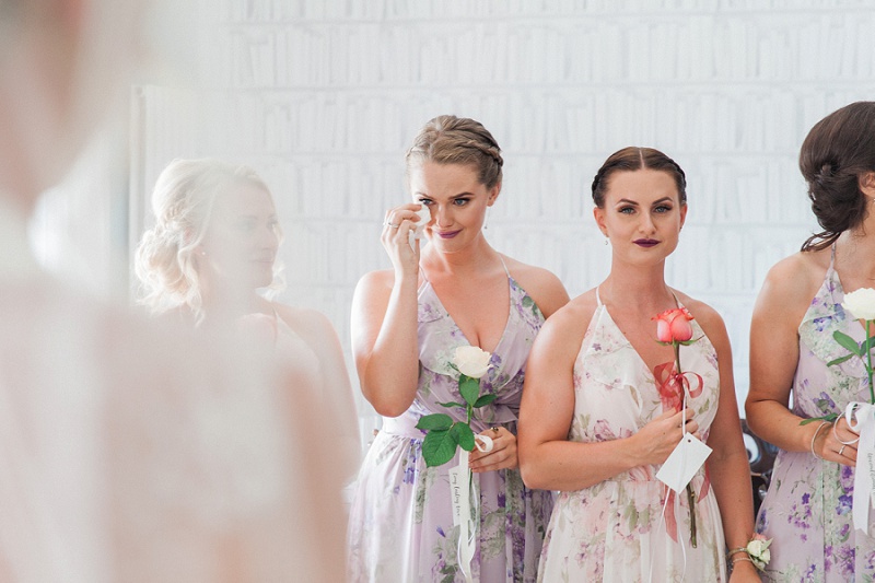 Bridesmaid in her Dessy dress tearing up as the bride sees her father
