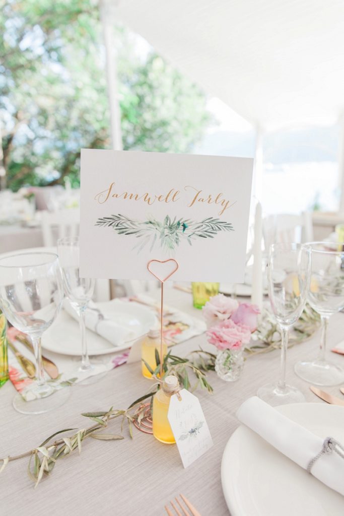Table name with rose gold heart shaped holder on the wedding tables at Seaside Restaurant