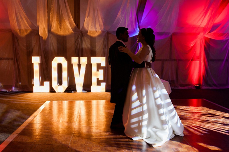 Bride and Groom with LOVE lights on the Dance floor at their wedding at Warren House