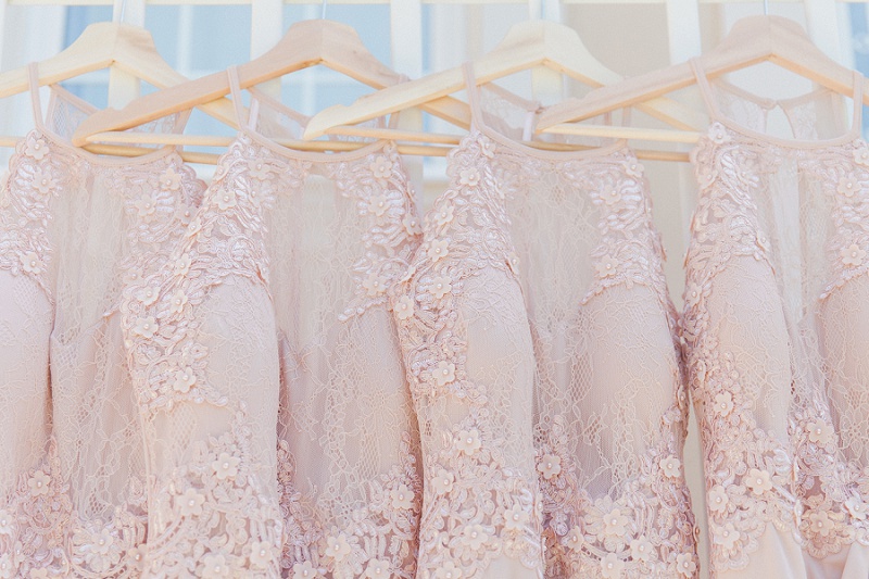 Soft pink bridesmaids dresses hanging in a row at Villa Rosa on Kefalonia