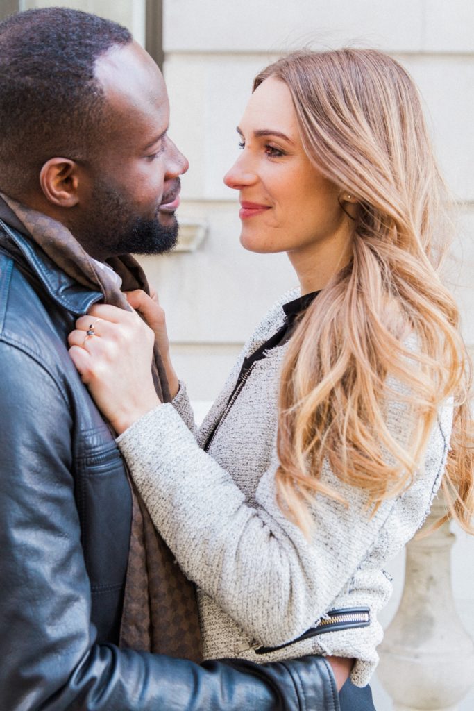 Bride to be looks lovingly at her fiance during their engagement shoot on the streets of Marylebone in London