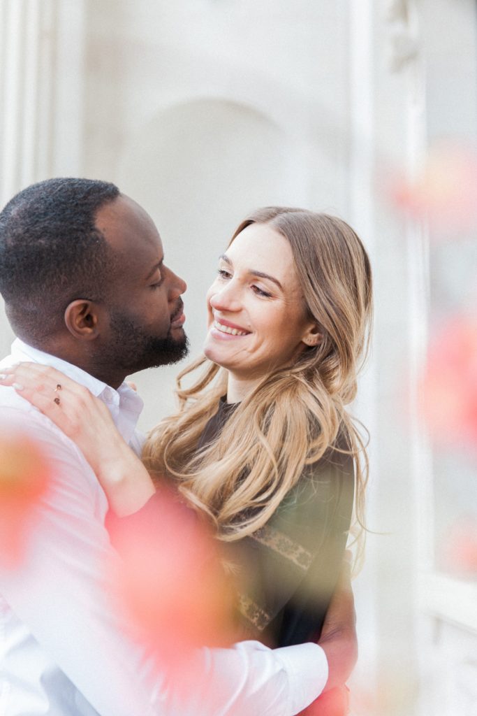 Couple smile during their engagement shoot in Marylebone