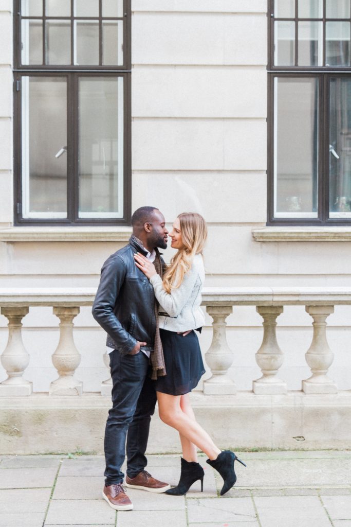 Couple embrace during their engagement shoot on the streets of Marylebone in London