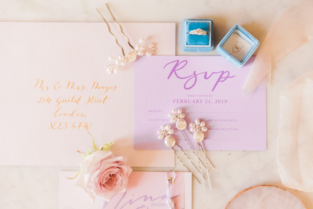 Pastel flatlay featuring wedding stationery by Scritto and accessories by PS With Love
