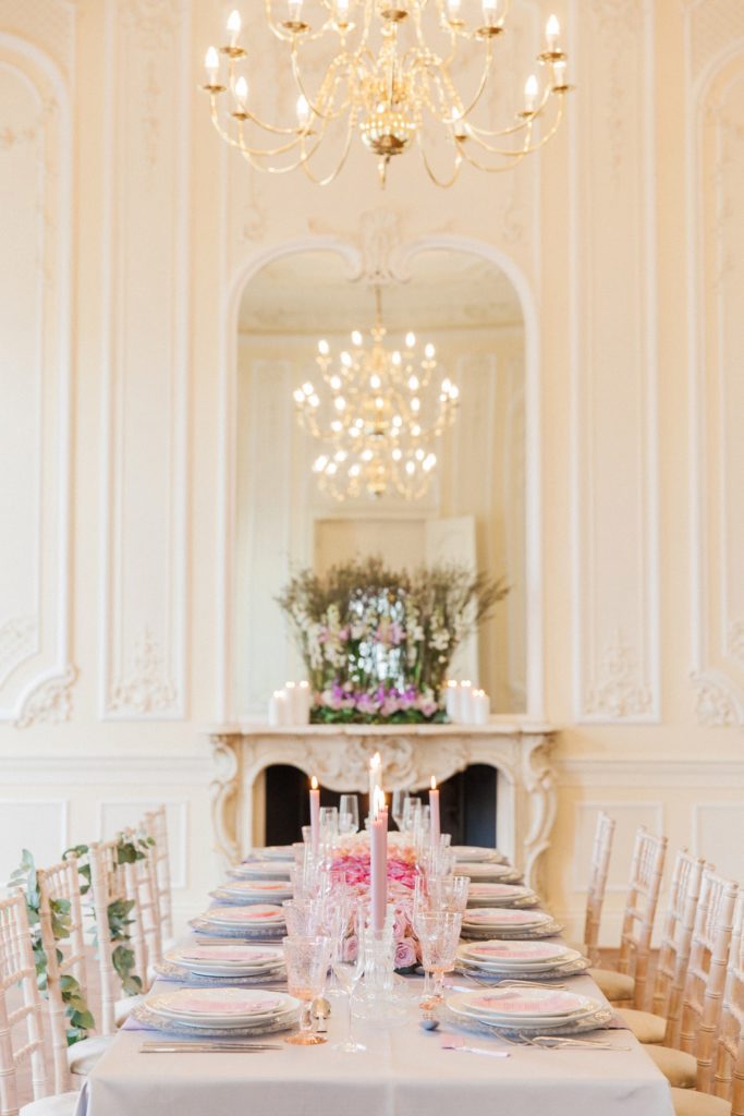 Tablescape featuring a decorated fireplace, chandelier and pink ombre wedding table runner at 10-11 Carlton House Terrace in London