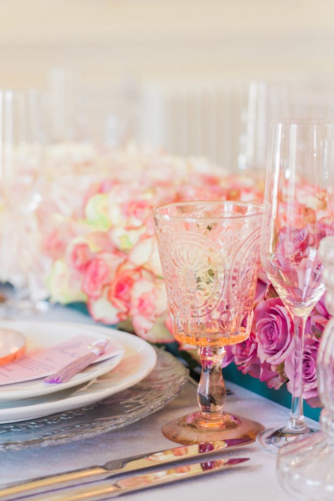Pink and clear glassware and ombre rose garland at a 10-11 Carlton House Terrace wedding
