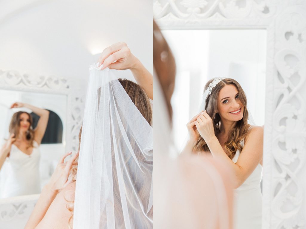The bride puts on her veil before her Santorini elopement