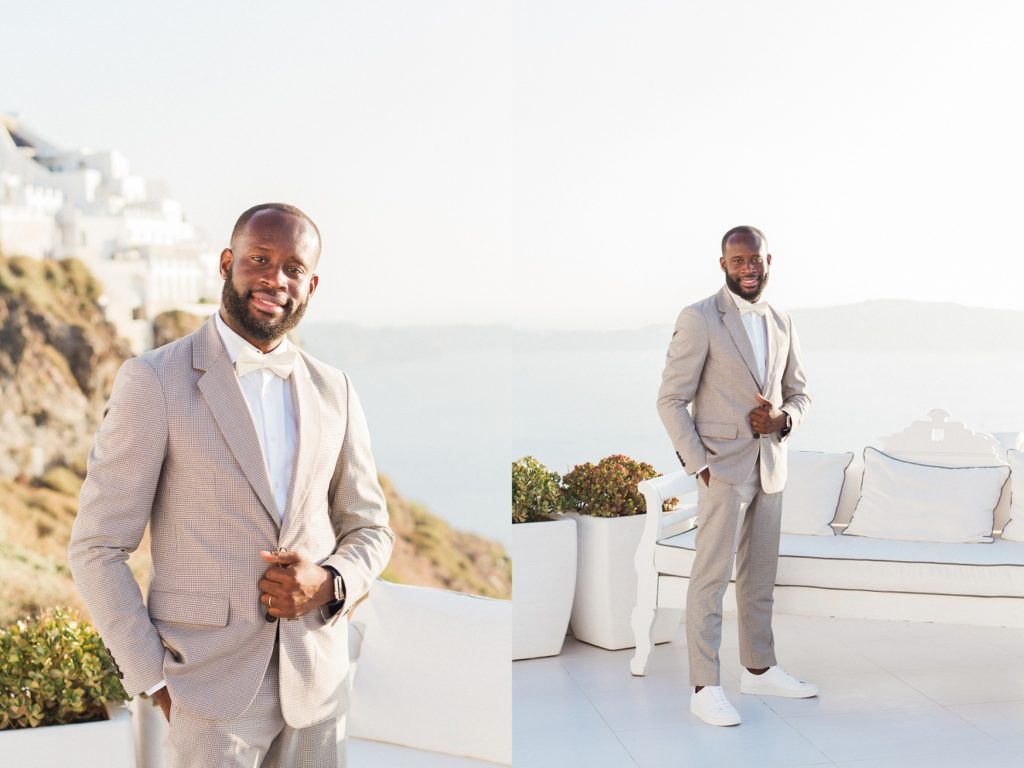 Groom Portraits showing his wedding outfit against a backdrop of Santorini cliffs and white houses