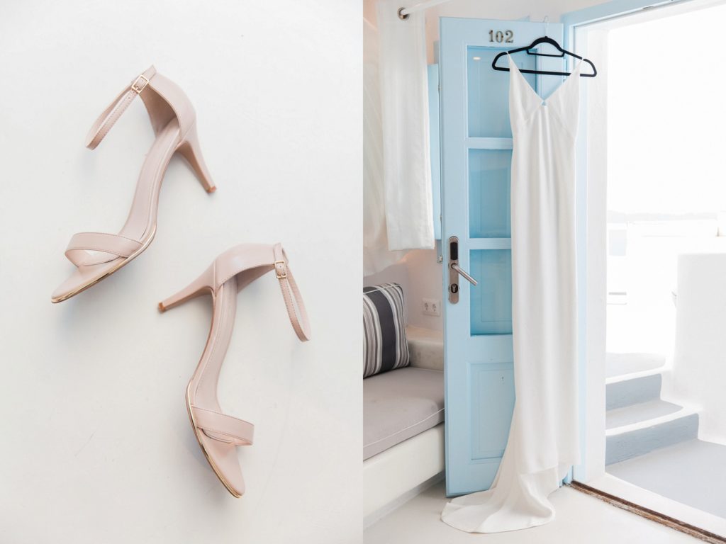 Carvela heels and the brides wedding dress hanging in the doorway of the honeymoon suite at Dana Villas Santorini