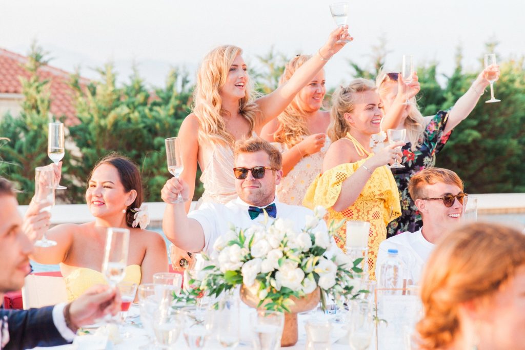 Wedding guests raise a toast at Emelisse Hotel on Kefalonia