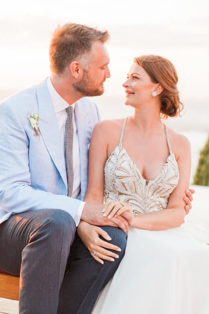 Couple smiling at each other during their couple portraits at Emelisse Hotel on Kefalonia