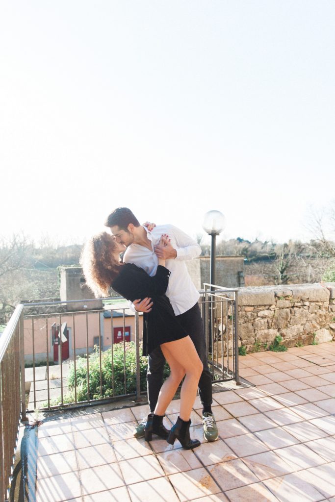 Italian couple kiss while dancing in the sunshine