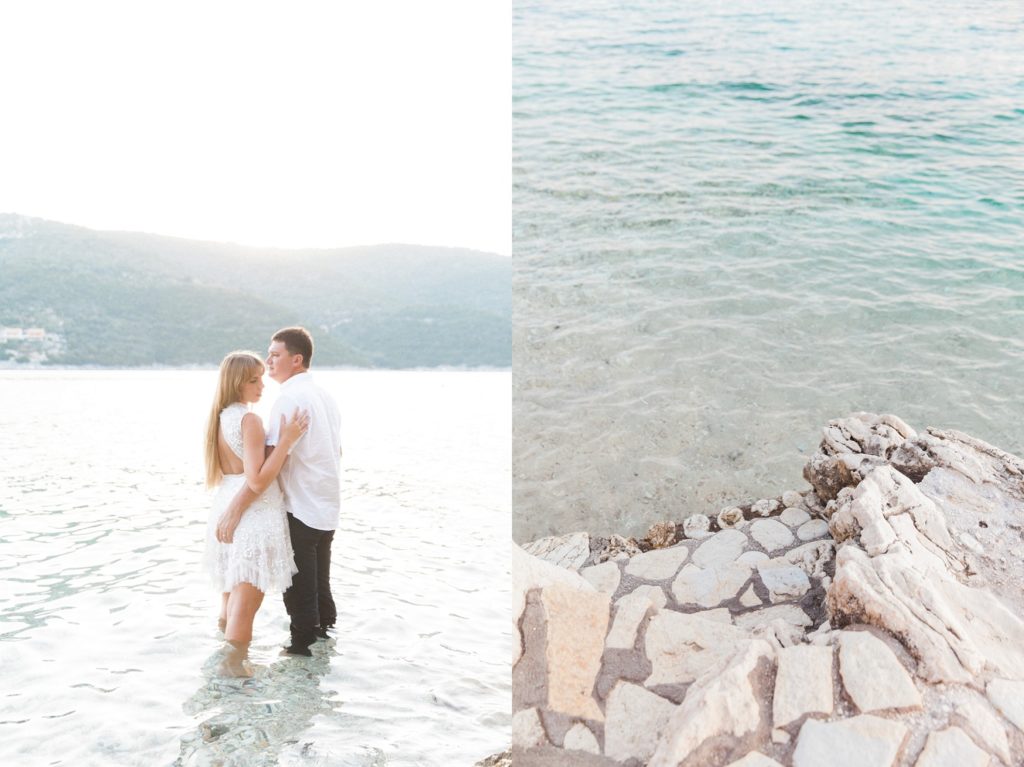 Couple standing in the sea next to stone steps at the San Nicolas Resort Hotel in Lefkada