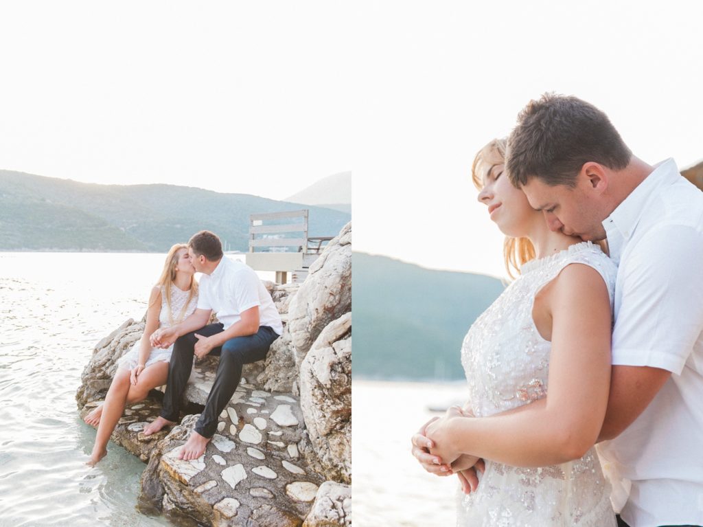 Bride and groom sit kissing on the rocks at San Nicolas Resort during their honeymoon photography session