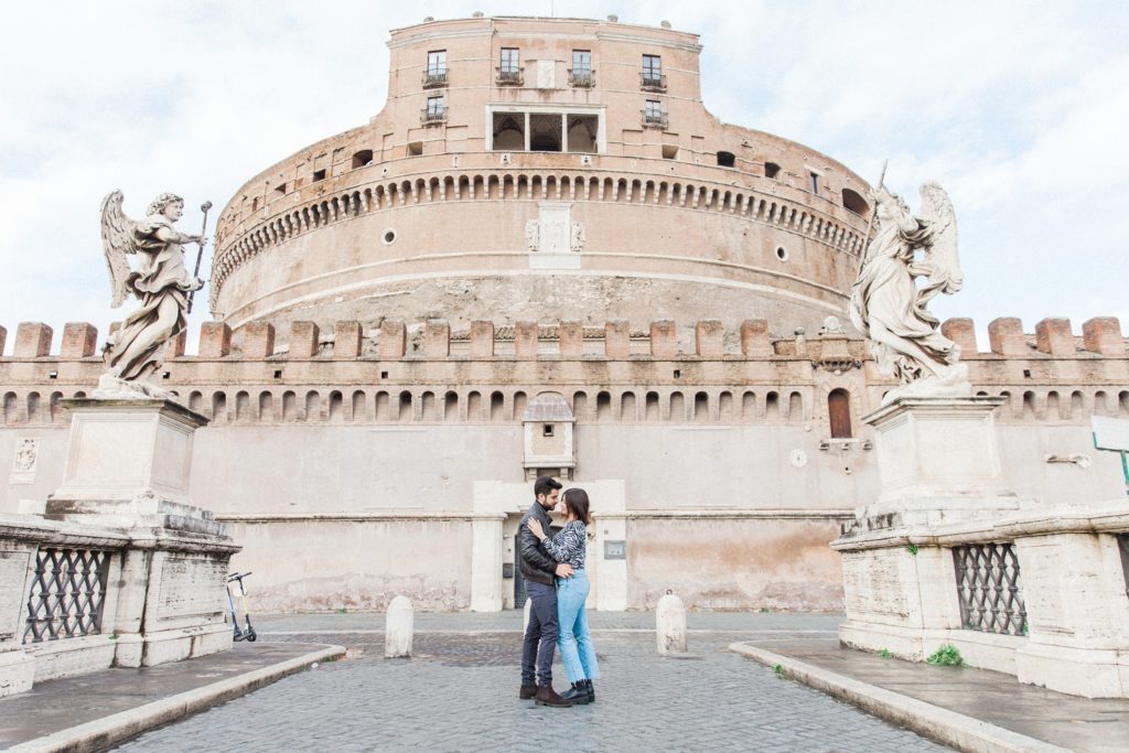 Couple embrace in front of Castel Sant'Angelo during their Rome couple photography session