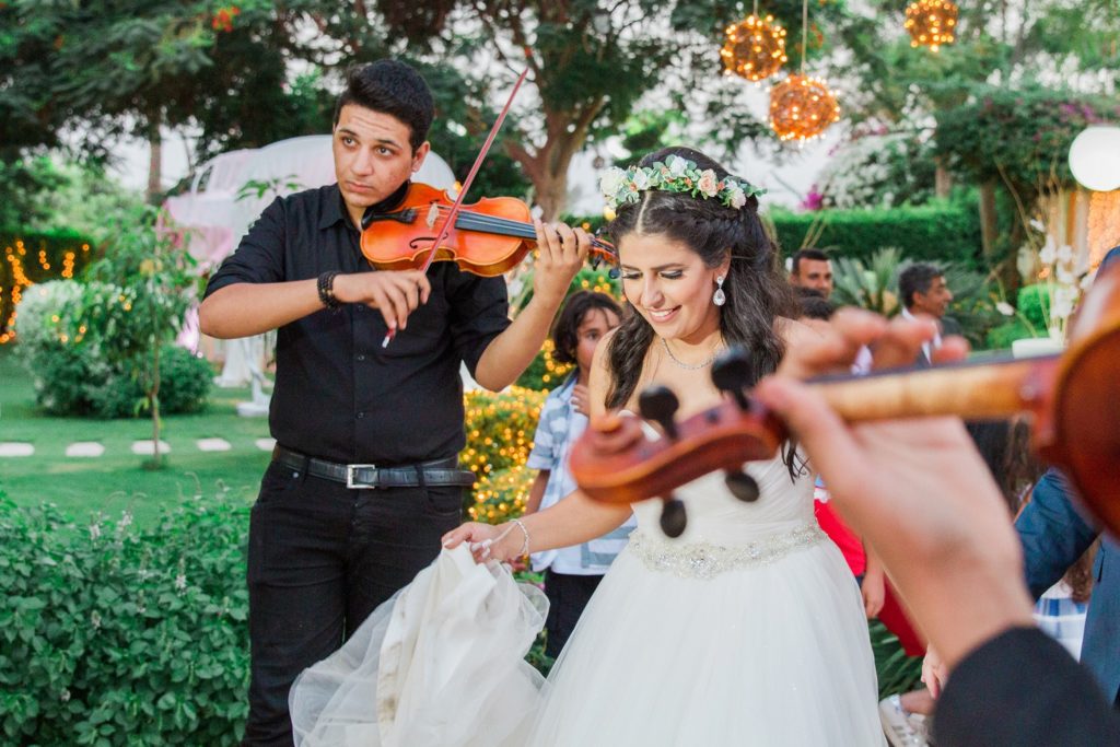 Bride and groom make their entrance to Plein Air wedding venue in Cairo accompanied by a string quartet