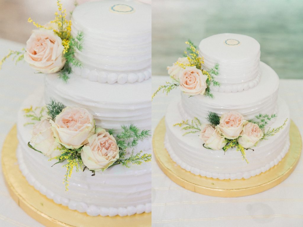 White wedding cake with soft pink rose details at Plein Air wedding venue in Cairo
