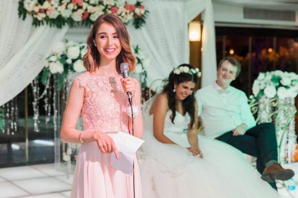 Bridesmaid wearing pink says a speech at Plein Air wedding venue in Cairo