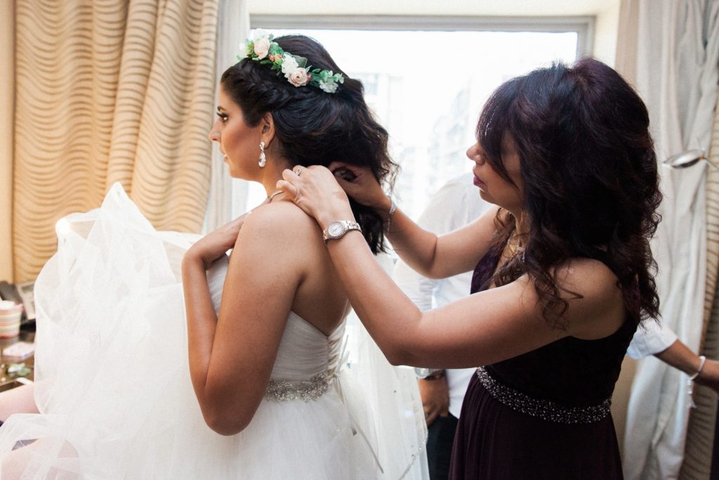 Mother-of-the-bride helps her daughter dress at the Radisson Blu Hotel in Cairo on the morning of her Egypt wedding