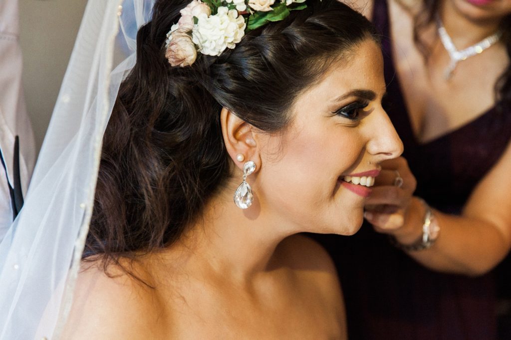 Bride smiles as she gets dressed on the morning of her wedding in Egypt