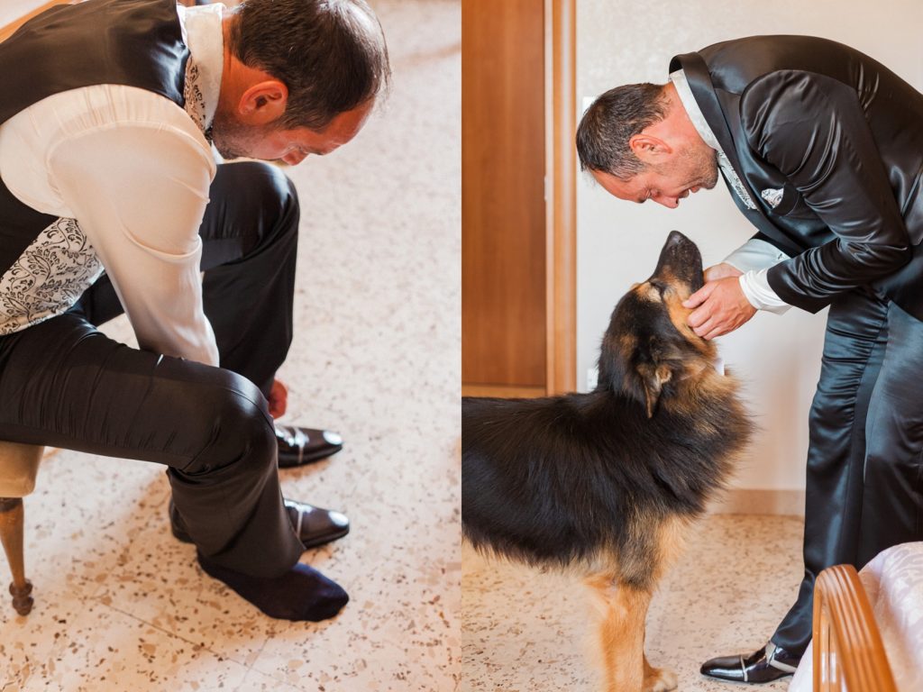 The groom puts on his wedding shoes with his dog on the morning of his wedding in Apulia