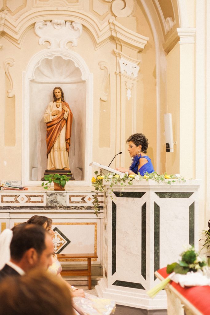 Mother-of-the-bride does a reading in a traditional church in Apulia