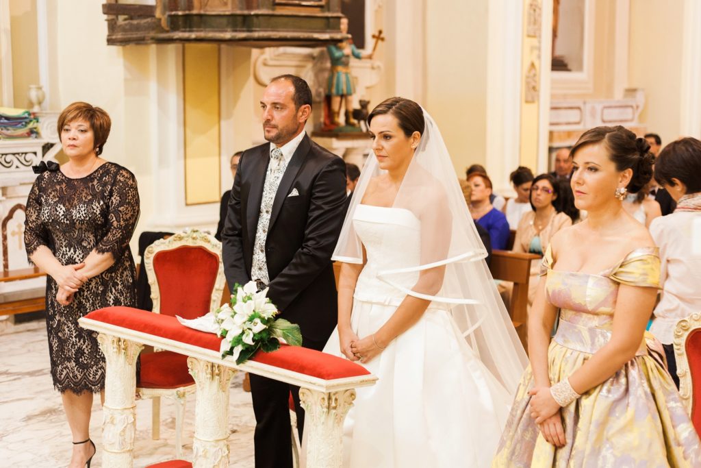 Italian couples and their witnesses in a traditional Italian church in Apulia
