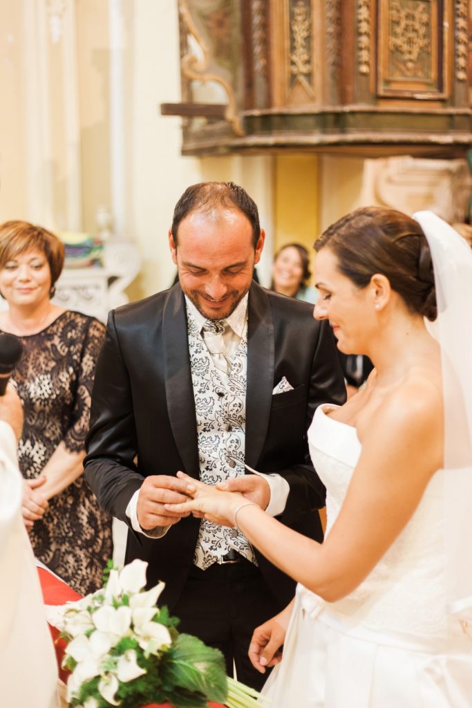 Italian couple exchange rings in a traditional church in Apulia