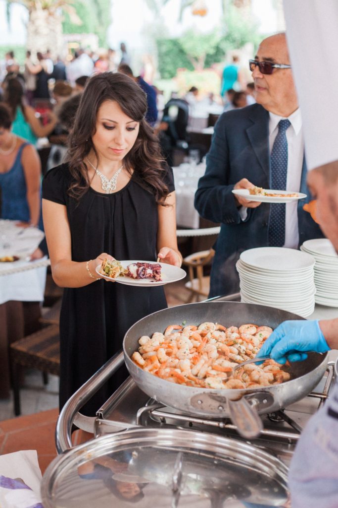 Wedding guests gets served prawns by a chef at the Convivium Hotel
