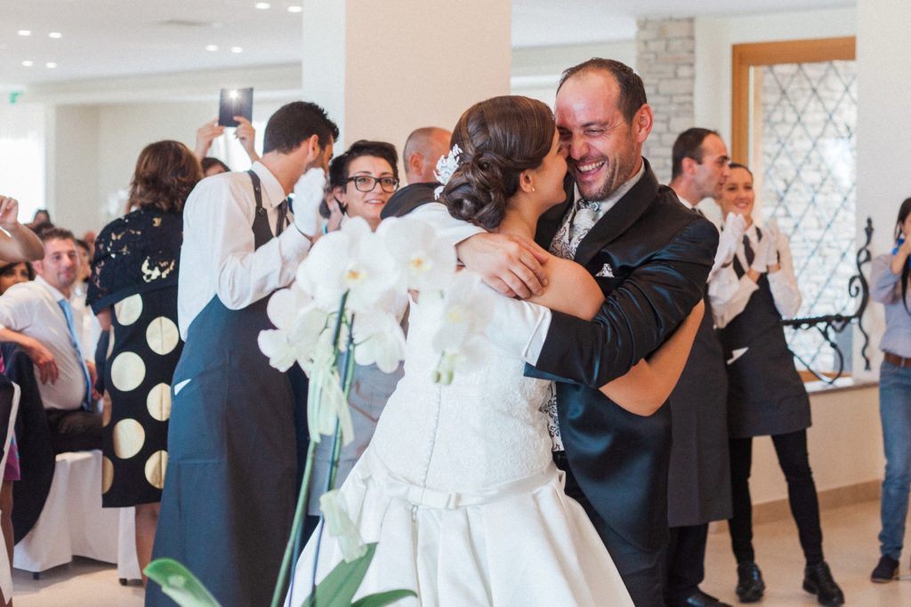 Italian bride and groom dance while surrounded by their wedding guests