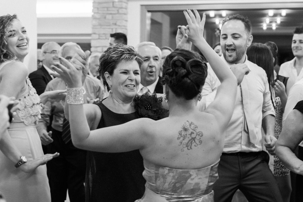 Wedding guests dance at a reception at the Convivium Hotel