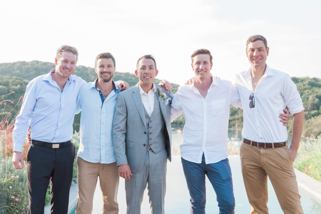 Groom and his friends pose on the terrace of his suite at Domotel Agios Nikolaos in Sivota